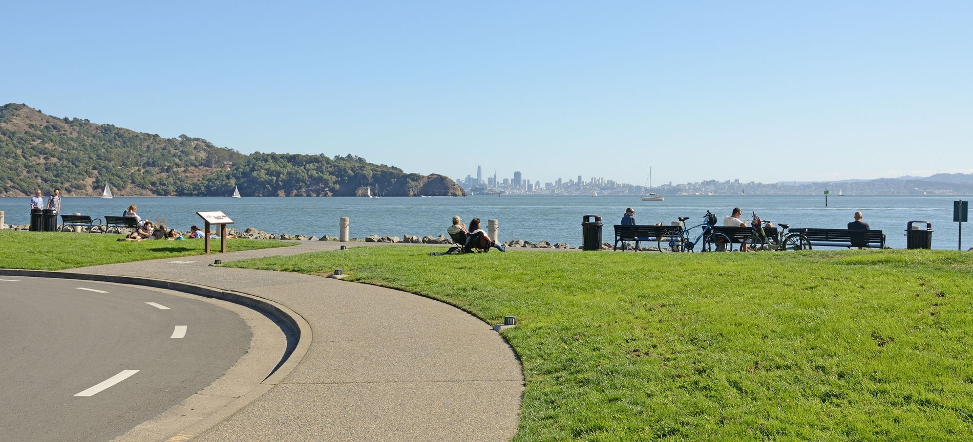 The shoreline path and lawn along Tiburon's waterfront, with the San Francisco skyline across the bay